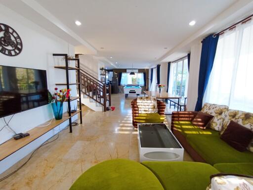 Spacious Living Room with Modern Amenities and Staircase