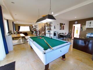 Spacious living room with pool table and open floor plan