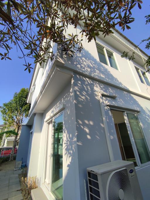 Exterior view of a modern two-story home with clear blue sky