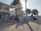 Exterior view of a residential building with a street and parked car