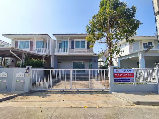 Exterior view of a two-story residential home with gated entry