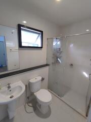 Modern bathroom interior with white fittings and a glass shower