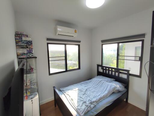 Modern bedroom with large windows and natural light