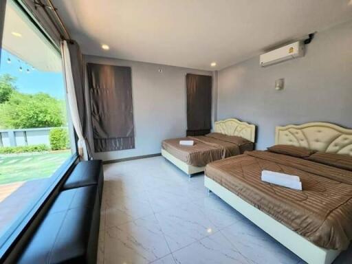 Spacious double bedroom with large windows and modern furniture