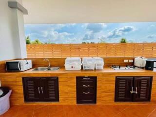 Modern kitchen with wooden cabinets and terra cotta tiles