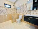 Modern bathroom interior with patterned wall tiles and elegant fittings