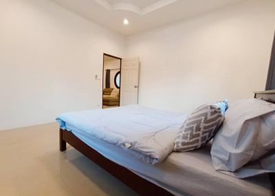 Spacious modern bedroom with minimalistic decor and en suite bathroom