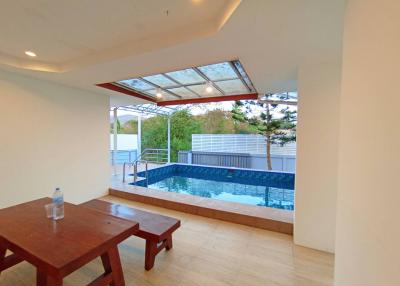 Spacious indoor pool area with natural light and seating