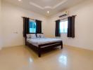 Spacious bedroom with king-sized bed, air conditioning, and ceramic flooring