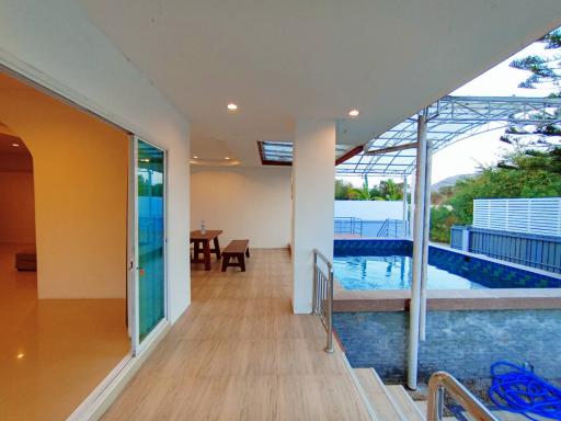 Spacious patio with pool view, ideal for dining and relaxation