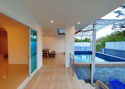 Spacious patio with pool view, ideal for dining and relaxation