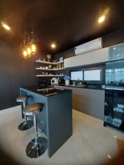 Modern kitchen with bar seating and stylish pendant lights