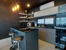 Modern kitchen with bar seating and stylish pendant lights
