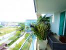 Spacious balcony with green plants and outdoor seating overlooking the area