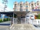 Exterior view of a residential apartment building with gated entrance