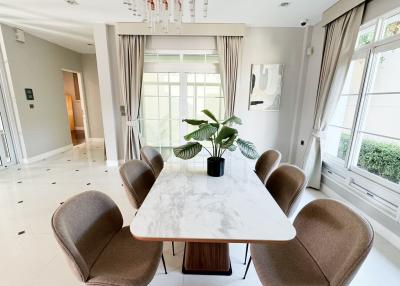 Spacious modern dining room with large windows and ample natural light