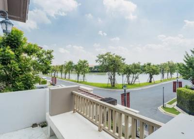 Balcony view overlooking a scenic lake with lush greenery