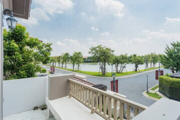 Balcony view overlooking a scenic lake with lush greenery