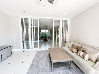 Spacious living room with large French doors and contemporary decor