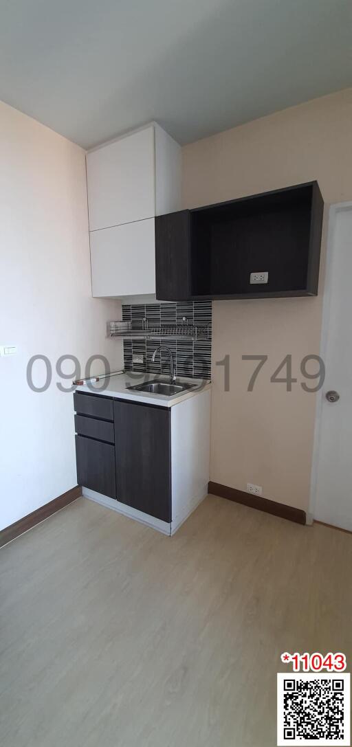 Compact modern kitchen with stainless steel appliances and white cabinetry