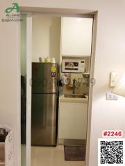 Compact kitchen with refrigerator and storage space