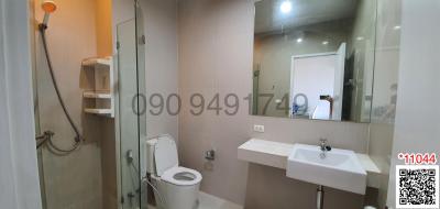 Modern bathroom with white fixtures, glass shower, and neutral color palette