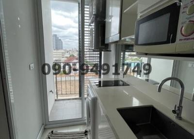 Modern kitchen with city view through the balcony door