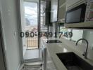 Modern kitchen with city view through the balcony door