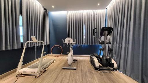 Modern Home Exercise Room with Treadmill, Exercise Bike, and Hula Hoop