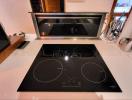 Modern kitchen with induction cooktop and under-cabinet lighting