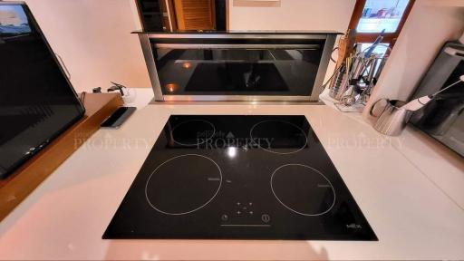 Modern kitchen with induction cooktop and under-cabinet lighting