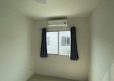 Bright and airy bedroom with window and air conditioning unit