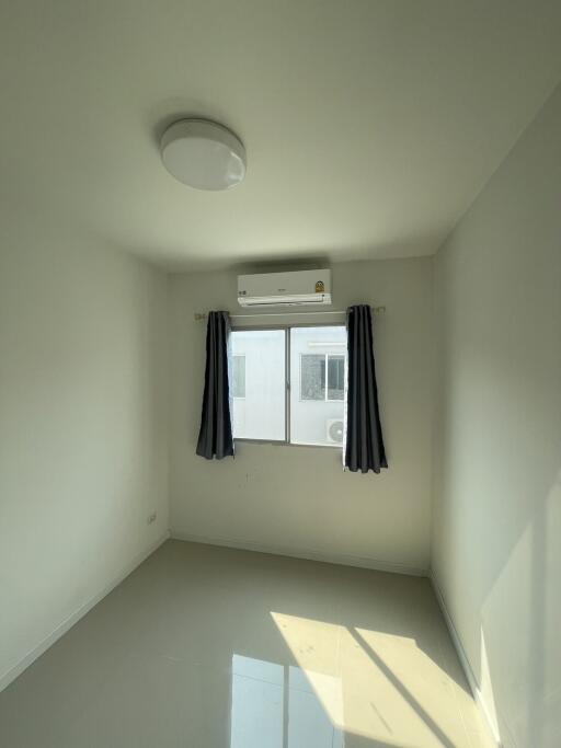 Bright and airy bedroom with window and air conditioning unit