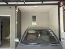 Home garage with a parked car and direct entry to the residence