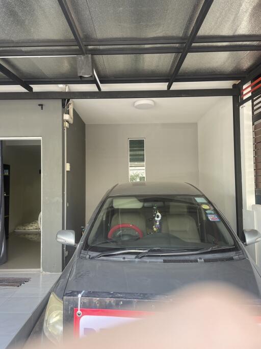 Home garage with a parked car and direct entry to the residence