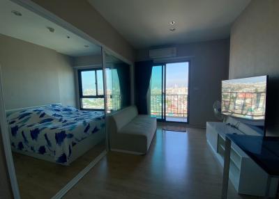 Modern bedroom with large windows and city view