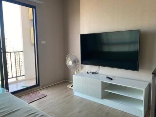 Modern living room with large window and flat screen TV