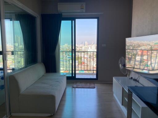 Bright living room with cityscape view through balcony doors