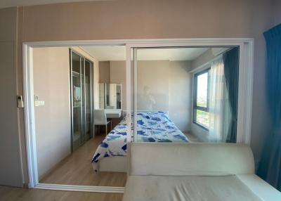 Bright and airy bedroom with a large window and mirrored closet doors