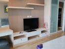 Modern bedroom with entertainment wall unit and wooden flooring