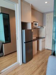 Modern kitchen with wooden cabinets and stainless steel appliances