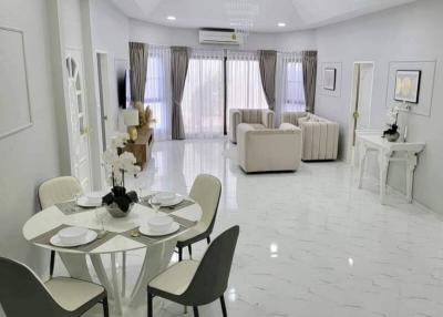 Spacious and elegantly furnished living room with dining area