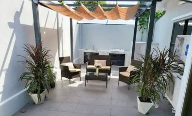 Cozy outdoor patio area with seating and plants