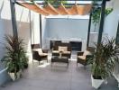 Cozy outdoor patio area with seating and plants