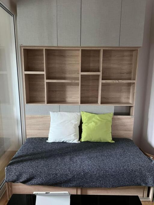 Cozy bedroom with a modern bed and built-in wooden shelf