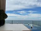 Infinity pool with a sea view beside a modern building