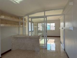 Spacious kitchen with marble countertops and ample natural light