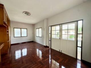 Spacious living room with wooden flooring and ample natural light