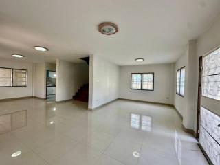 Spacious and bright empty living space with staircase and multiple windows