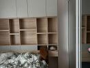 Cozy bedroom interior with built-in wardrobe and shelving units